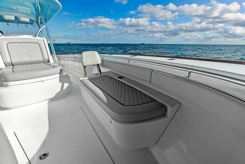 Slide: The Image of 2021 Valhalla Boatworks V-37 interior with cushioned seating, ocean view, and clear sky. - 10