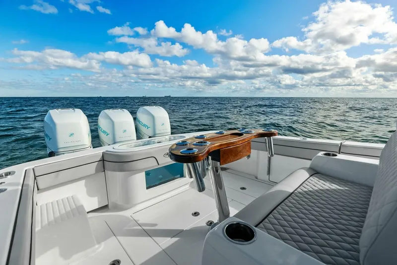 Slide: The Image of 2021 Valhalla Boatworks V-37 on open sea, featuring luxurious seating and multiple outboard engines. - 25