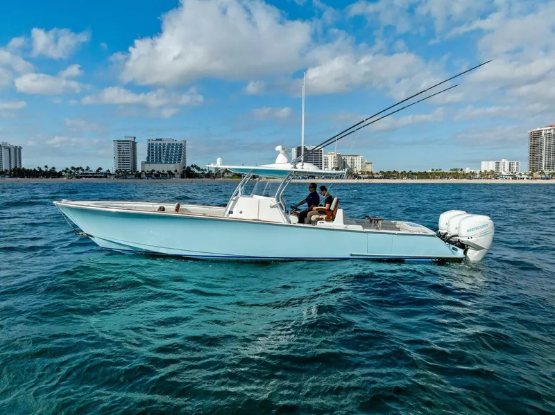 Slide: The Image of 2021 Valhalla Boatworks V-37 cruising on clear blue water near city skyline. - 29