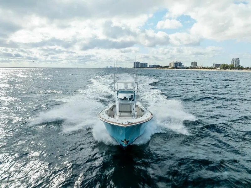 Slide: The Image of 2021 Valhalla Boatworks V-37 cruising on open water under a cloudy sky. - 37