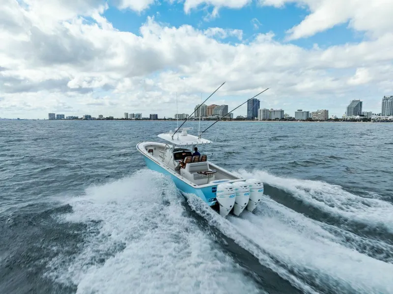 Slide: The Image of 2021 Valhalla Boatworks V-37 cruising on open water with city skyline in background. - 40