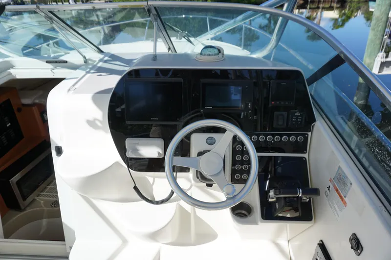 Slide: The Image of 2008 Hydra-Sports Vector 2900 VX boat dashboard with steering wheel and navigation controls. - 22