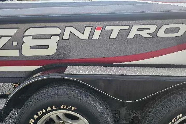 Slide: The Image of 2013 Nitro Z-8 boat trailer with bold logo and radial tires. - 2
