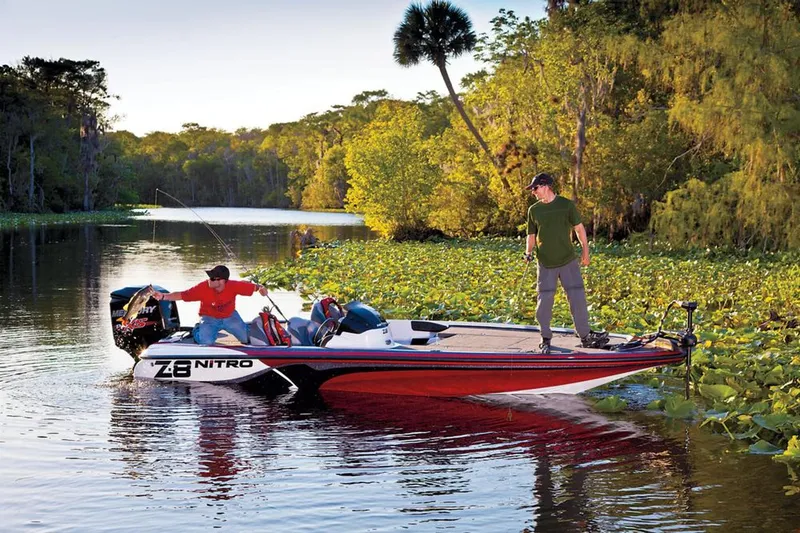 Slide: The Image of Manufacturer Provided Image: Two people fishing on a 2013 Nitro Z-8 boat in a lush, scenic river. - 5