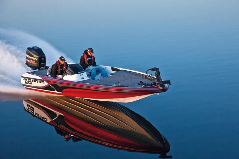 Slide: The Image of Manufacturer Provided Image: 2013 Nitro Z-8 boat speeding on calm water, reflecting vividly. - 7