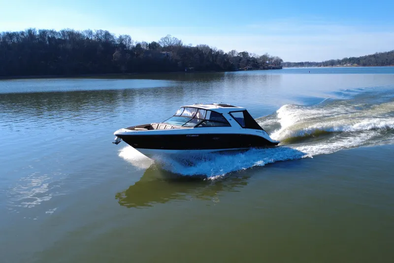 Slide: The Image of 2022 Sea Ray SLX 400 cruising on a serene lake under a clear blue sky. - 14