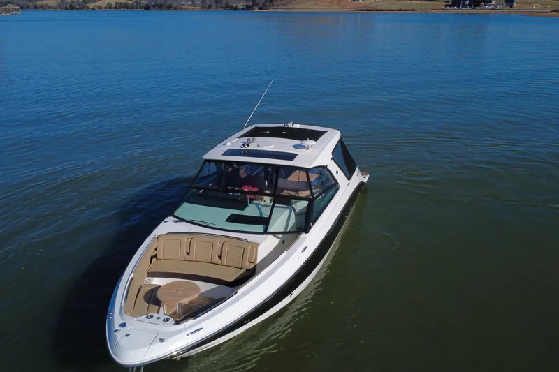 Slide: The Image of 2022 Sea Ray SLX 400 luxury boat cruising on a calm lake. - 21