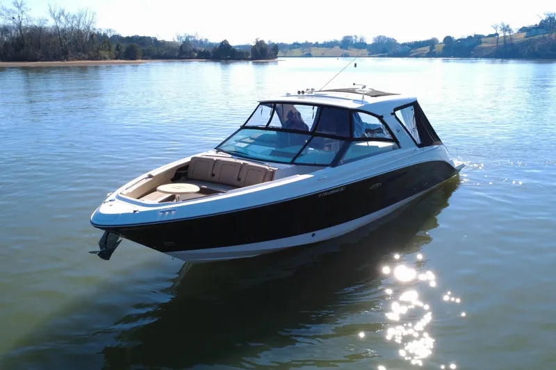 Slide: The Image of 2022 Sea Ray SLX 400 boat on a calm lake under clear skies. - 24