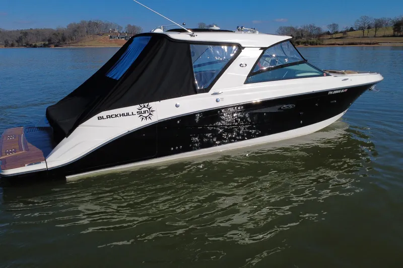 Slide: The Image of 2022 Sea Ray SLX 400 boat on calm water, featuring sleek black and white design. - 26