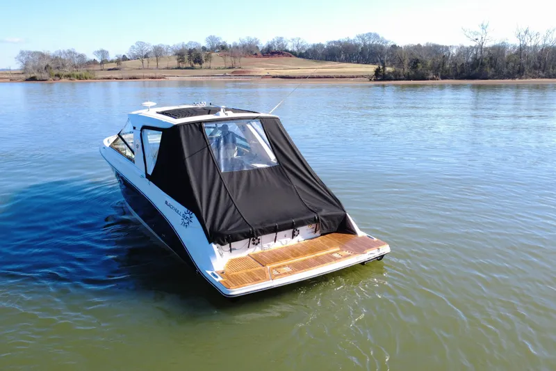 Slide: The Image of 2022 Sea Ray SLX 400 boat on a calm lake with scenic background. - 29