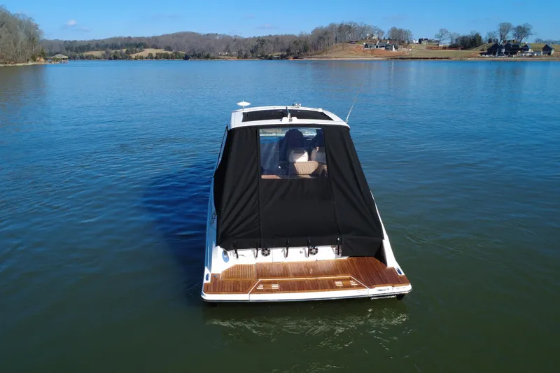 Slide: The Image of 2022 Sea Ray SLX 400 boat on a calm lake with scenic background. - 33