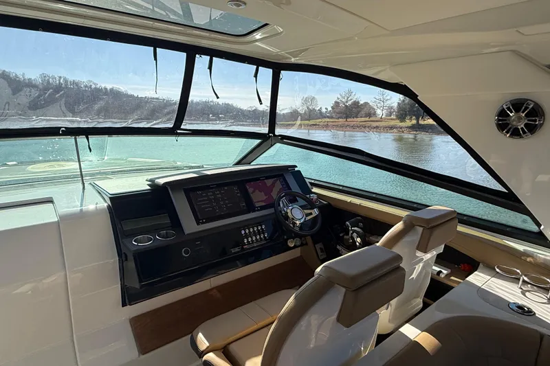 Slide: The Image of Interior view of 2022 Sea Ray SLX 400 boat cockpit with modern controls and scenic water view. - 35