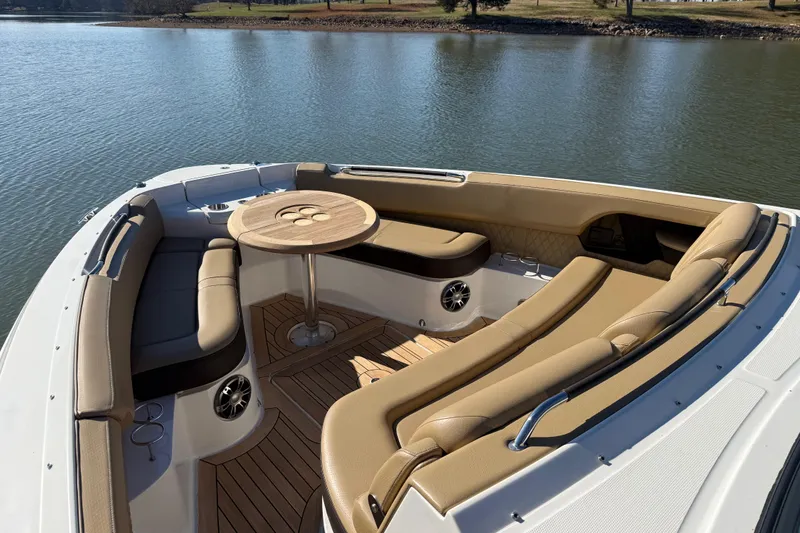 Slide: The Image of Luxurious 2022 Sea Ray SLX 400 boat interior with elegant seating and table on water. - 38