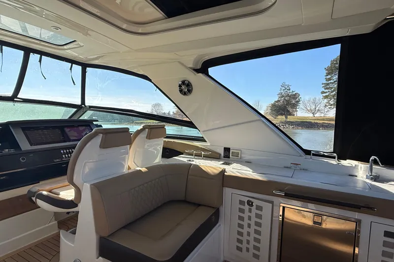 Slide: The Image of Interior of 2022 Sea Ray SLX 400 yacht with luxurious seating and modern dashboard. - 42