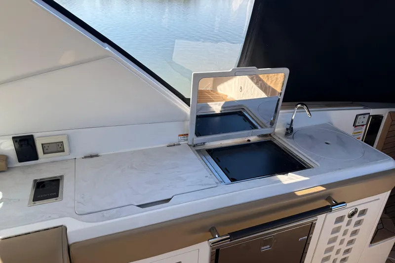 Slide: The Image of Outdoor kitchen on 2022 Sea Ray SLX 400 yacht with grill and sink. - 43