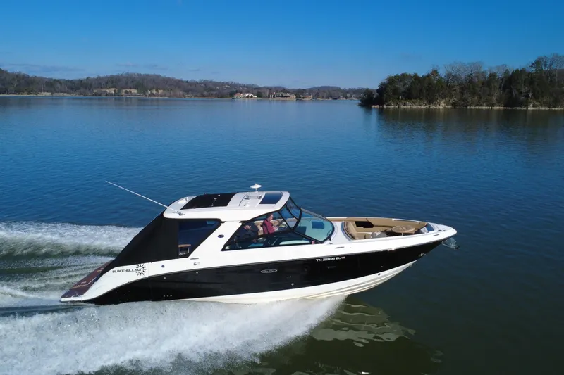 Slide: The Image of 2022 Sea Ray SLX 400 cruising on a serene lake under a clear blue sky. - 5