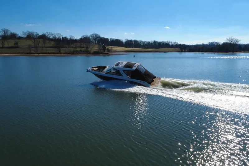 Slide: The Image of 2022 Sea Ray SLX 400 cruising on a serene lake under a clear blue sky. - 9
