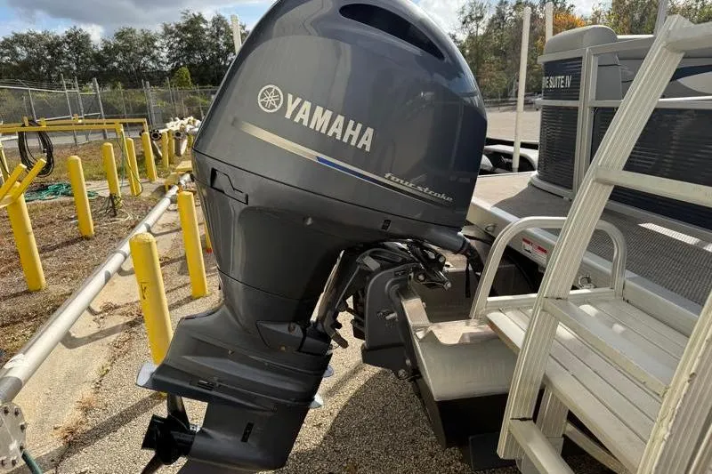 Slide: The Image of 2023 Bennington 22SSR with Yamaha outboard motor, parked on a sunny day. - 11