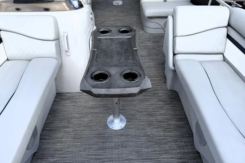 Slide: The Image of 2023 Bennington 22SSR boat interior with gray seating and table with cup holders. - 16