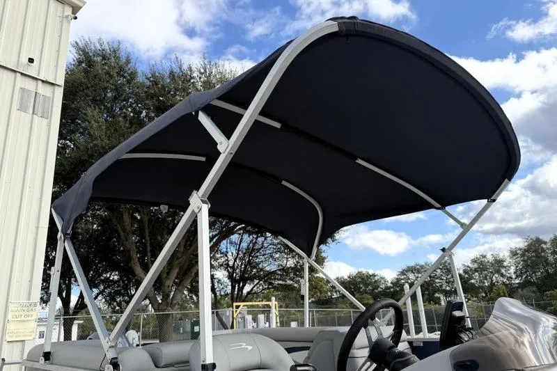 Slide: The Image of 2023 Bennington 22SSR pontoon boat with canopy under blue sky. - 31