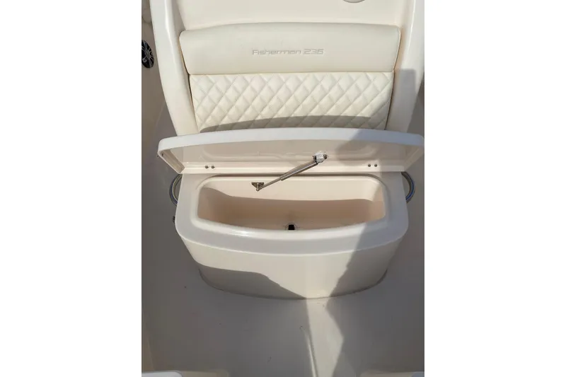 Slide: The Image of 2025 Grady-White Fisherman 236 boat seat with storage compartment open. - 10