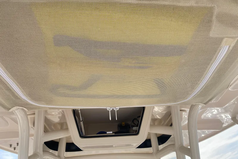 Slide: The Image of 2025 Grady-White Fisherman 236 boat interior with mesh sunroof and overhead storage. - 11