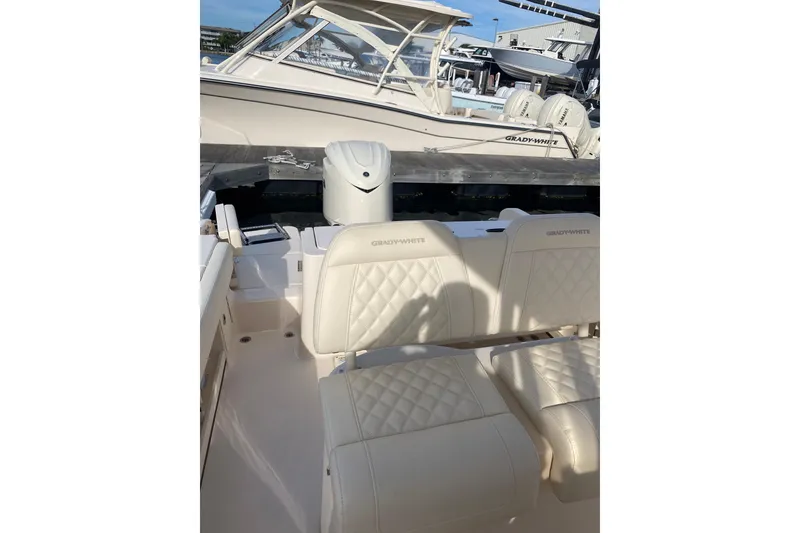 Slide: The Image of 2025 Grady-White Fisherman 236 boat interior with cushioned seating and storage. - 15