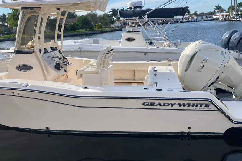 Slide: The Image of 2025 Grady-White Fisherman 236 boat docked, featuring Yamaha outboard motor. - 2