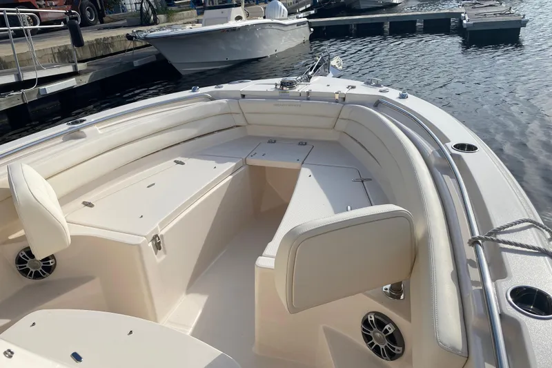 Slide: The Image of 2025 Grady-White Fisherman 236 boat interior with seating and storage, docked at marina. - 6