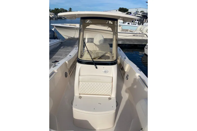 Slide: The Image of 2025 Grady-White Fisherman 236 boat docked, showcasing sleek design and comfortable seating. - 9