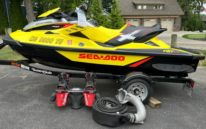 The Image of 2015 Sea-Doo RXT260 jet ski on trailer with accessories, parked outdoors. - 0
