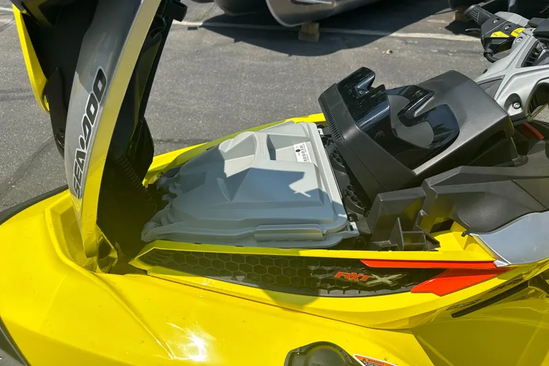 Slide: The Image of 2015 Sea-Doo RXT260 jet ski, yellow, open storage compartment, close-up view. - 10