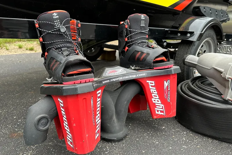 Slide: The Image of Flyboard with boots next to a 2015 Sea-Doo RXT260 trailer on pavement. - 16