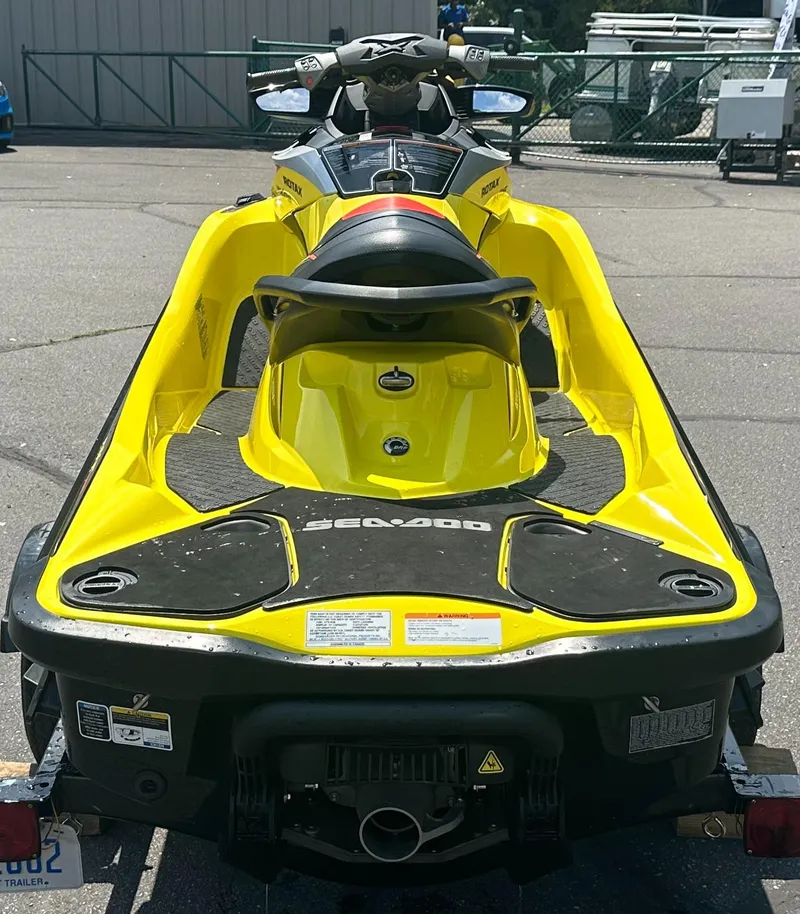 Slide: The Image of 2015 Sea-Doo RXT260 jet ski, yellow and black, parked on a trailer. - 4