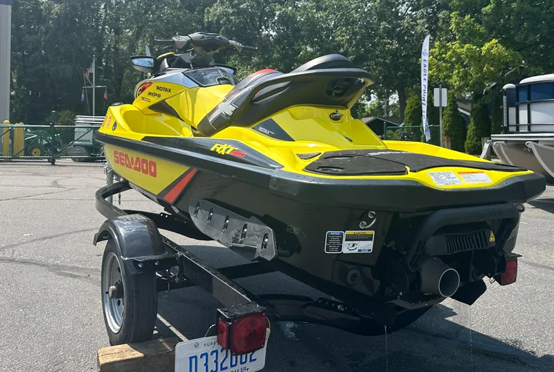 Slide: The Image of 2015 Sea-Doo RXT260 jet ski on trailer, parked outdoors. - 5