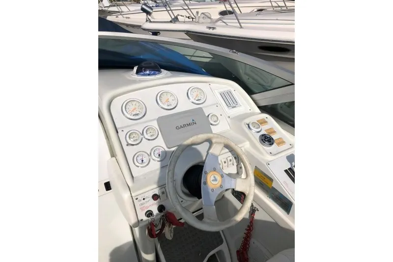 Slide: The Image of 1998 Formula 382 FASTech boat dashboard with Garmin navigation and multiple gauges. - 11