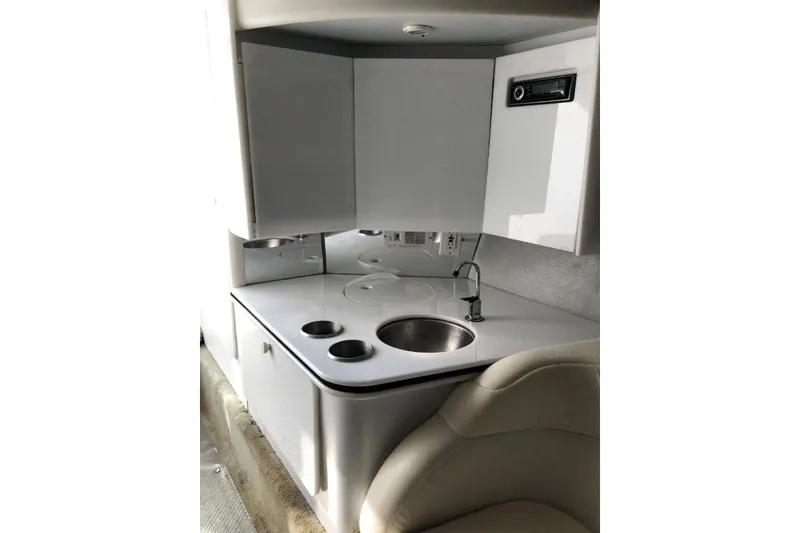 Slide: The Image of Interior of 1998 Formula 382 FASTech boat featuring a compact kitchenette with sink and storage. - 15