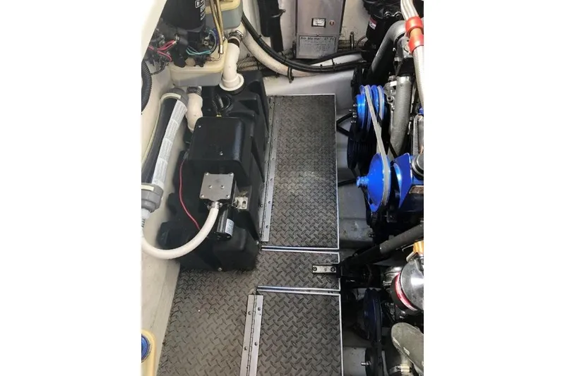 Slide: The Image of Engine compartment of a 1998 Formula 382 FASTech boat, showcasing mechanical components and wiring. - 19