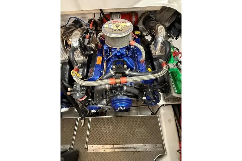 Slide: The Image of 1998 Formula 382 FASTech engine compartment with vibrant blue detailing and performance components. - 24