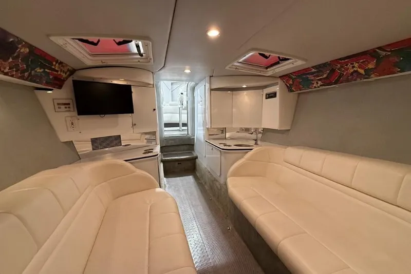 Slide: The Image of Interior of 1998 Formula 382 FASTech boat with white seating and modern amenities. - 26