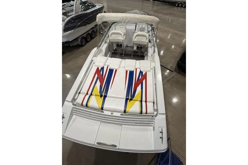 Slide: The Image of 1998 Formula 382 FASTech boat with colorful seating design in a showroom. - 5