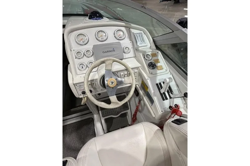 Slide: The Image of 1998 Formula 382 FASTech boat cockpit with Garmin navigation and white steering wheel. - 6