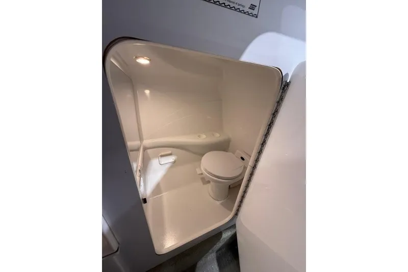 Slide: The Image of 1998 Formula 382 FASTech boat interior bathroom with toilet and compact design. - 8