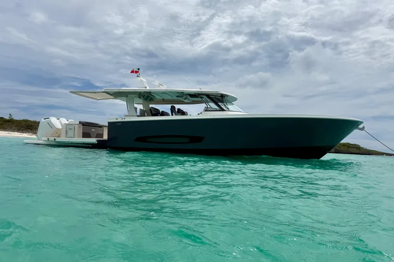 Slide: The Image of 2026 Regal 50 SAV yacht anchored in turquoise waters under a cloudy sky. - 17