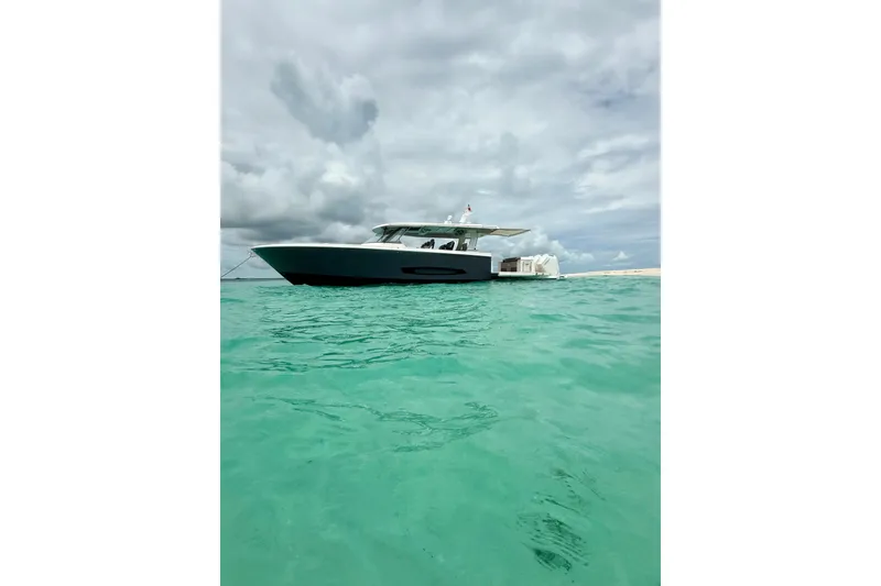 Slide: The Image of 2026 Regal 50 SAV yacht on turquoise water under cloudy sky. - 18