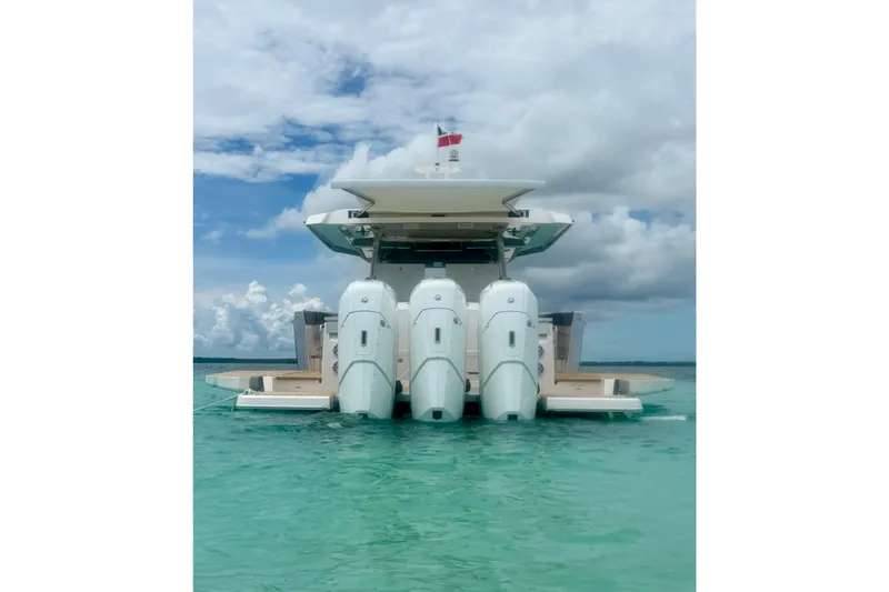 Slide: The Image of 2026 Regal 50 SAV yacht with triple outboard engines on turquoise water. - 19