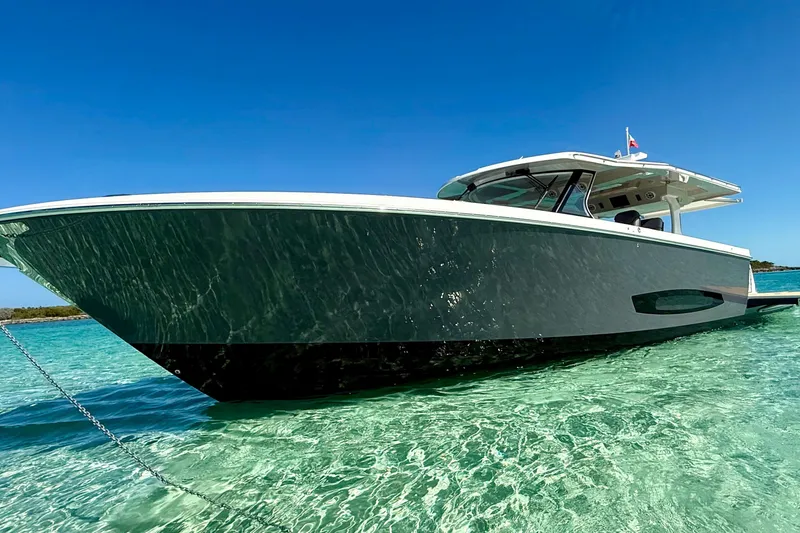 Slide: The Image of 2026 Regal 50 SAV boat anchored in clear turquoise water under a bright blue sky. - 20