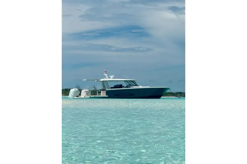 Slide: The Image of 2026 Regal 50 SAV yacht on clear turquoise water under a cloudy sky. - 26