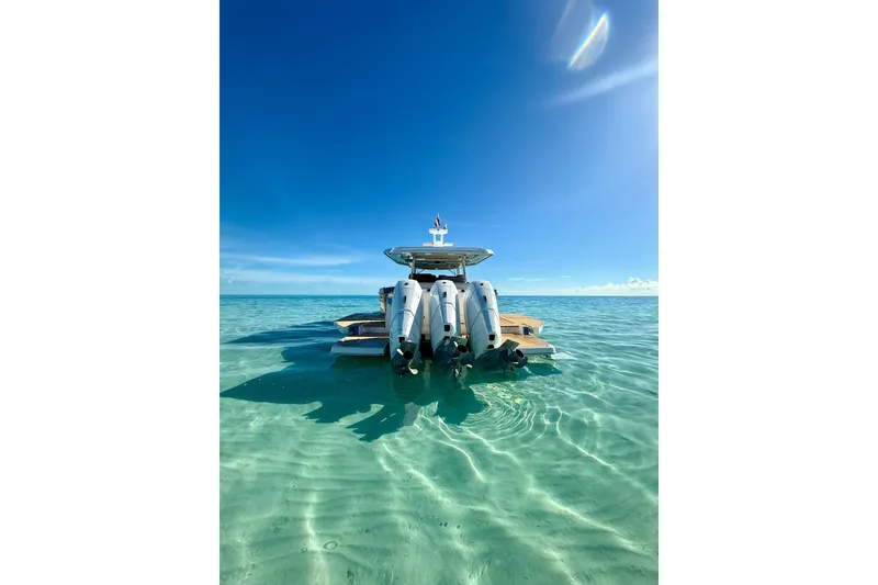 Slide: The Image of 2026 Regal 50 SAV yacht in clear turquoise waters under a bright blue sky. - 29