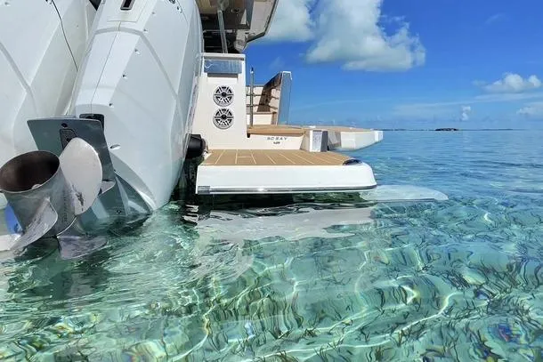 Slide: The Image of 2026 Regal 50 SAV yacht in clear tropical waters, showcasing sleek design and powerful engines. - 31